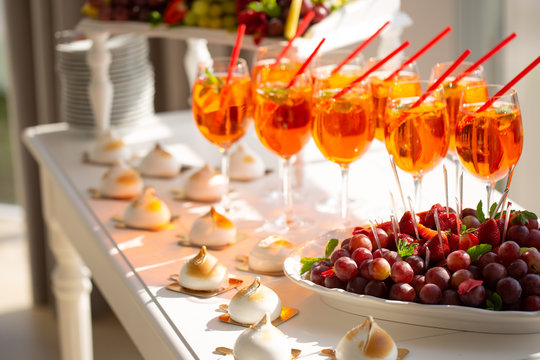 Image of strawberry cocktails, fruit and biscuits closeup