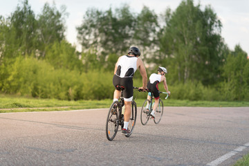 Fototapeta na wymiar Velo race. Two riders on bicycle at the asphalt road