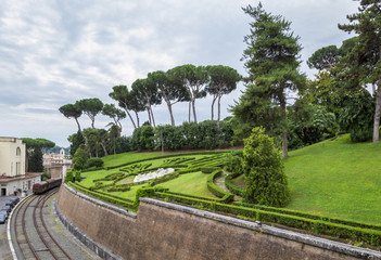 View at Vatican Gardens with beautiful green lawns and  trees, railway and station, Rome, Italy.