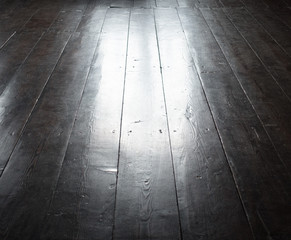 Dark wooden flor perspective view with light point in center