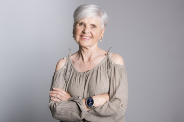 elderly woman on studio dark gray background