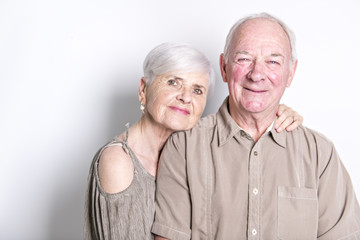 Senior couple posing on studio white background