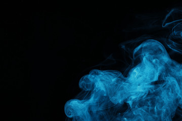 blue spiritual smoke on black background with copy space