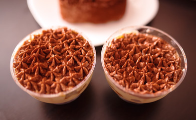 glassful with Italian cake tiramisu stuffed inside