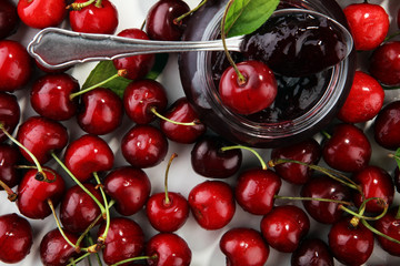 Rustic jar with cherry jam and fresh cherries, homemade preserves