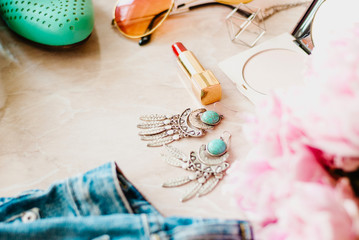 Obraz premium Styled flat lay background. Pink peony flower with jeans and shoes.