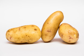 Young potatoes isolated on white background. The crop is new. Flat, top view