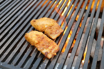 Spicy Chicken grilling over flames