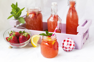 Retro glass jar of detox water with strawberries, lemon and mint