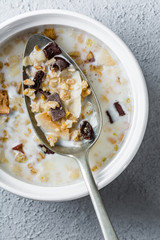 Muesli with chocolate and coconut on spoon