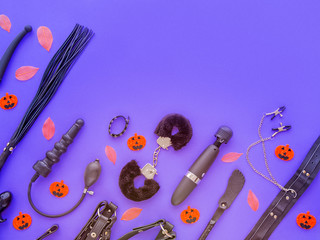 Sex toys, fallen leaves and artificial pumpkins with terrible faces. The image is suitable for advertising a sex shop for Halloween. Artistic noise increase