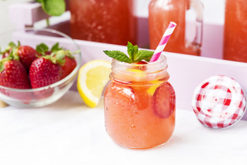 Retro glass jar of detox water with strawberries, lemon and mint