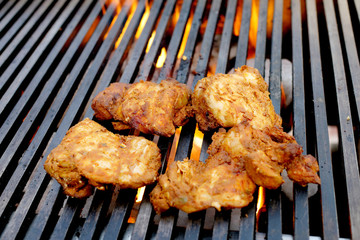 Mediterranean Chicken grilling over flames