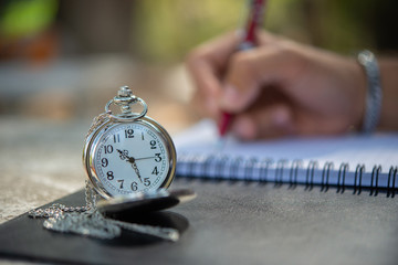 Deadline Time concept.Deadline day,Young man mark and noted schedule on book or diary at desk.Close...