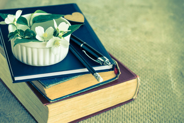 Old books, diary and jasmine flower.  Reading a sentimental novel.