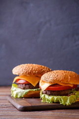 Picture of two hamburgers on wooden table