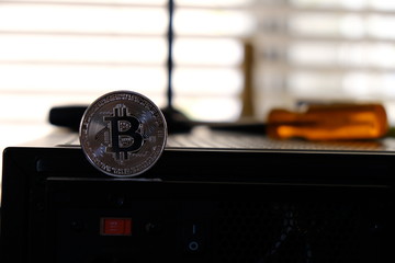 Bronze Bitcoin standing on computer case
