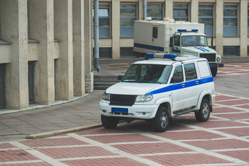 Police vehicle and Prisoner transport vehicle standing near the courthouse in Russia.