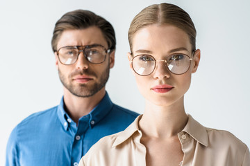 close-up portrait of attractive young man and woman in stylish clothing and eyeglasses isolated on white - obrazy, fototapety, plakaty