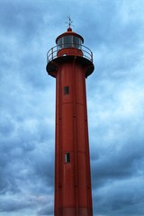 Red lighthouse in the port of Cacilhas village in Lisbon