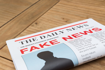 Newspaper on a coffee table with the headline fake news