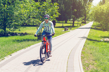 Obraz premium A cyclist in a helmet rides a bicycle path
