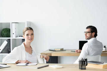 young business colleagues sitting at workplace in office