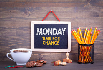 Monday time for change. Business Concept. Chalkboard on a wooden background.