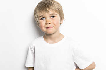 cute five year old boy studio portrait on white background