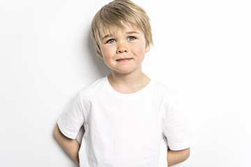 cute five year old boy studio portrait on white background