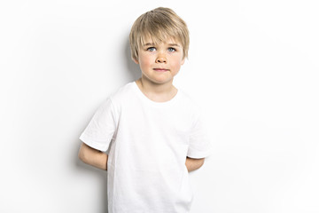 cute five year old boy studio portrait on white background