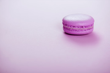 Violet macaroons on violet background.
