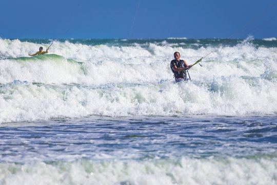 Young athletic man riding kite surf on a sea