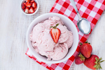 Bowl of Strawberry Ice Cream With Red Fruits on Checkered Napkin