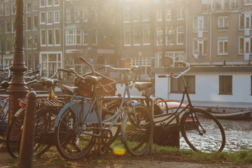 bicycles parked near canal at Amsterdam, Netherlands on sunset