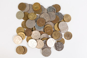 a bunch of Russian coins on a white background of five and 10 rubles.