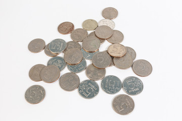 a bunch of Russian coins on a white background of five rubles.