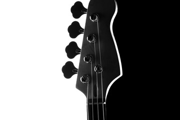 Silhouette of an electric bass guitar on a contrasting black and white background.