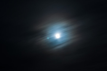 night sky and moon in the clouds at long exposure. the theme of 