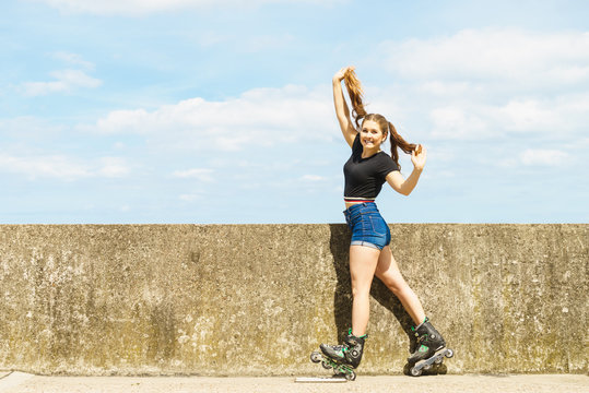 Fit girl with roller skates outdoor