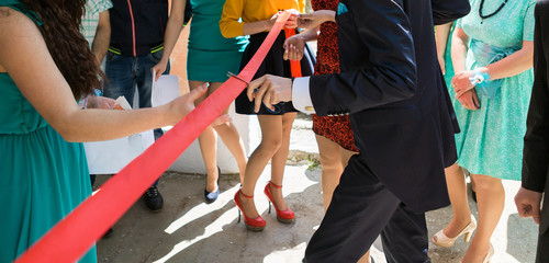 Cutting a red ribbon with scissors, inaugurated ribbon - obrazy, fototapety, plakaty