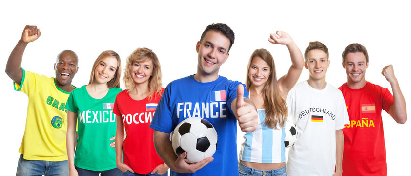 Optimistic french soccer fan with ball and fans from other countries