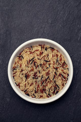 uncooked healthy rice in white bowl