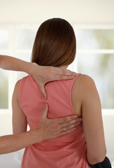 Fototapeta na wymiar Woman having chiropractic back adjustment. Osteopathy, Physiotherapy, sport injury rehabilitation concept