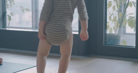 Toddler interrupting his mother's yoga practice