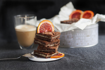 Home made brownies with cream on dark background