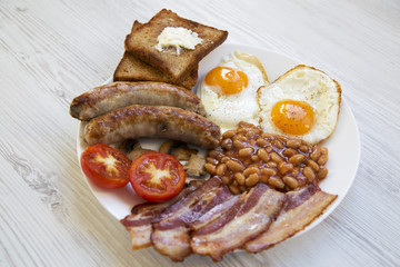 English breakfast on a white wooden background, closeup. Side view.