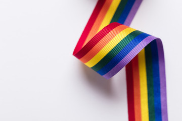 Gay pride LGBT rainbow ribbon on white background