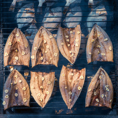 Fish Smoking Process. Smoked Mackerel and flounder. Close Up Smoking. Veiw from above