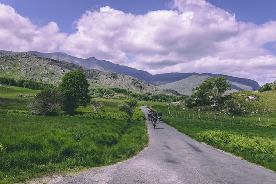 People riding bicycles on the scenic roads of Black Valley in county Kerry, Ireland
